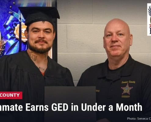 Fostoria News Jail inmate and sheriff's officer at GED graduation ceremony in Seneca County.